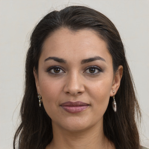 Joyful latino young-adult female with long  brown hair and brown eyes