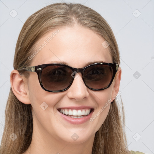 Joyful white young-adult female with long  brown hair and blue eyes