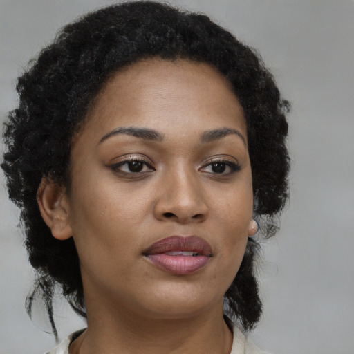 Joyful black young-adult female with medium  brown hair and brown eyes