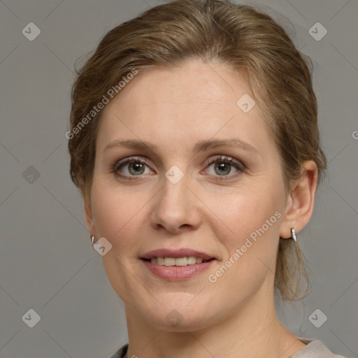 Joyful white adult female with medium  brown hair and grey eyes