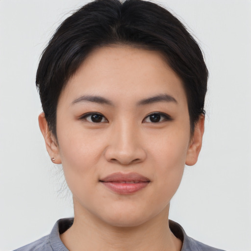 Joyful asian young-adult female with short  black hair and brown eyes
