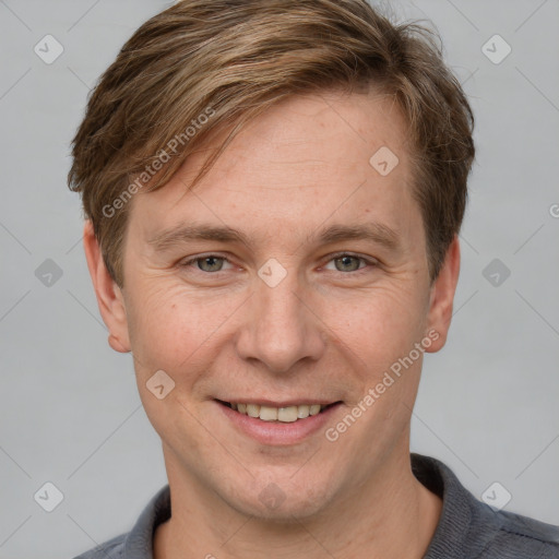 Joyful white adult male with short  brown hair and grey eyes