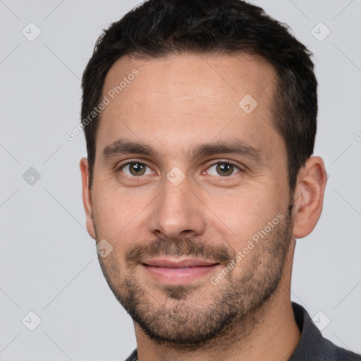 Joyful white young-adult male with short  brown hair and brown eyes