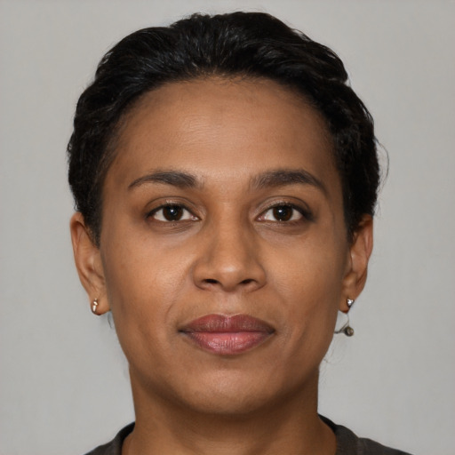 Joyful black young-adult female with short  brown hair and brown eyes