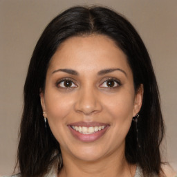 Joyful latino young-adult female with long  brown hair and brown eyes