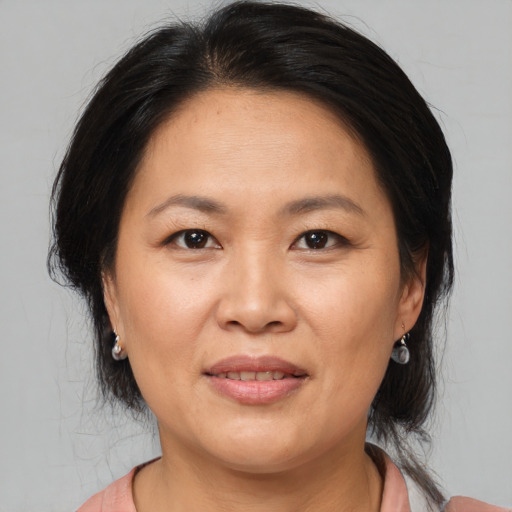 Joyful asian adult female with medium  brown hair and brown eyes