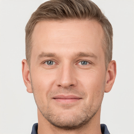 Joyful white adult male with short  brown hair and grey eyes