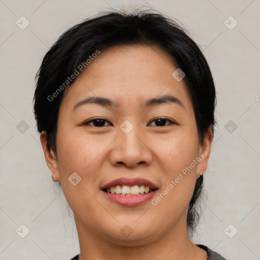 Joyful asian young-adult female with short  black hair and brown eyes