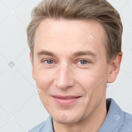 Joyful white adult male with short  brown hair and grey eyes