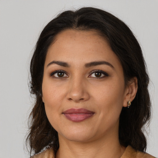 Joyful latino young-adult female with medium  brown hair and brown eyes