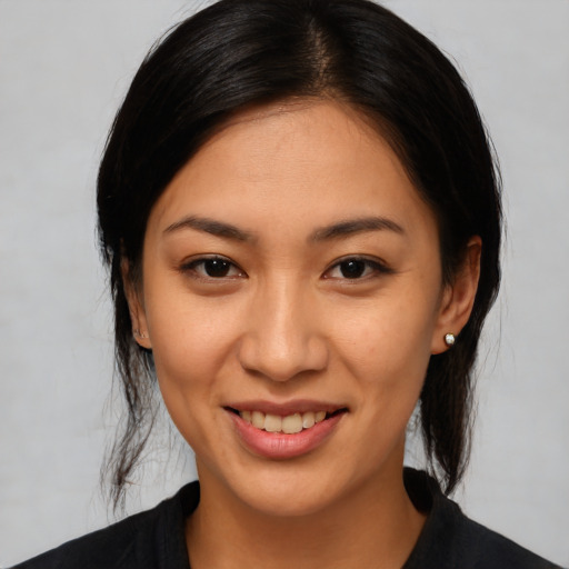 Joyful latino young-adult female with medium  black hair and brown eyes