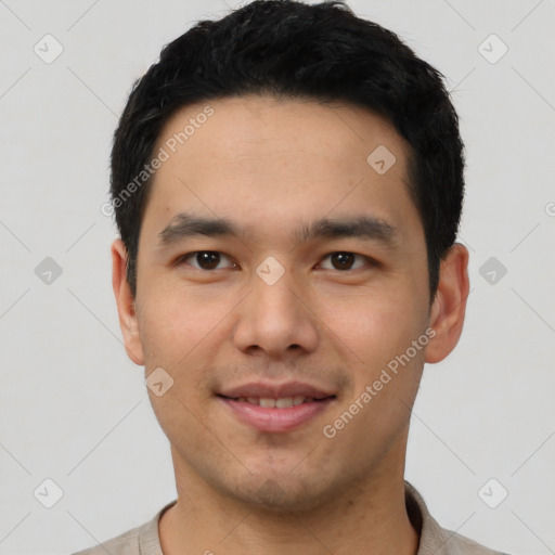 Joyful white young-adult male with short  black hair and brown eyes