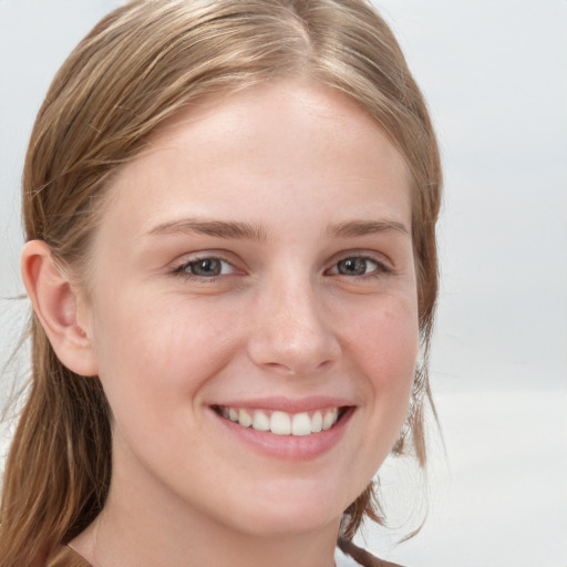 Joyful white young-adult female with long  brown hair and blue eyes