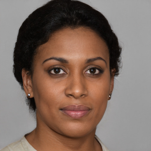 Joyful black young-adult female with short  brown hair and brown eyes