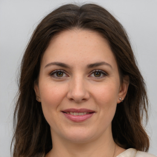 Joyful white young-adult female with long  brown hair and grey eyes