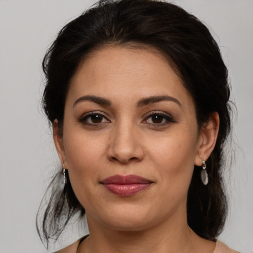 Joyful white adult female with medium  brown hair and brown eyes