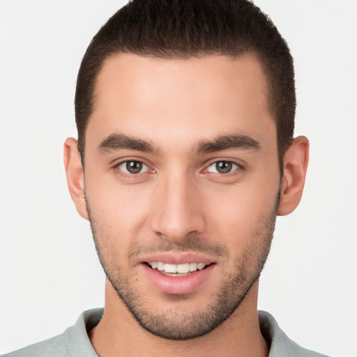 Joyful white young-adult male with short  brown hair and brown eyes