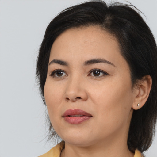 Joyful asian young-adult female with medium  brown hair and brown eyes