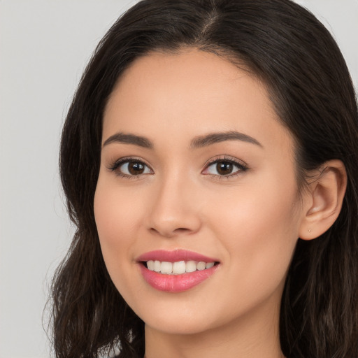 Joyful white young-adult female with long  brown hair and brown eyes