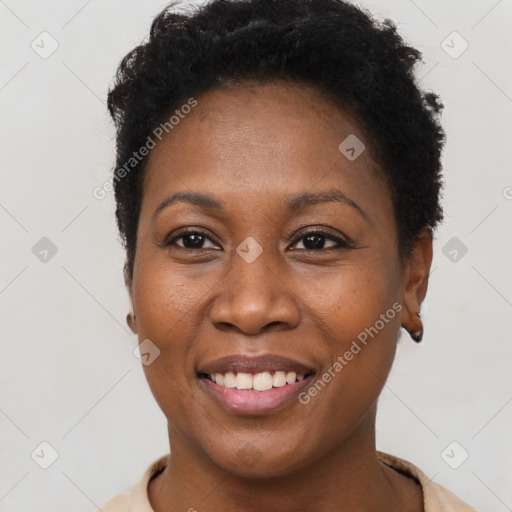 Joyful black young-adult female with short  black hair and brown eyes