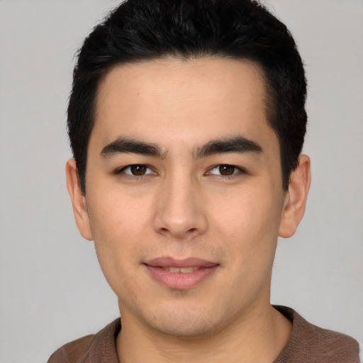 Joyful latino young-adult male with short  black hair and brown eyes