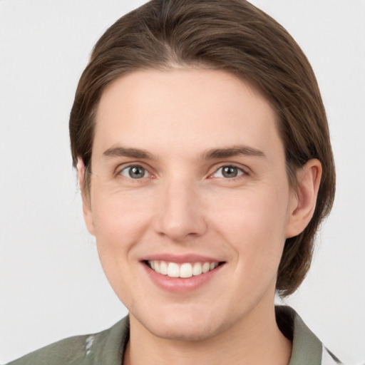 Joyful white young-adult female with medium  brown hair and grey eyes