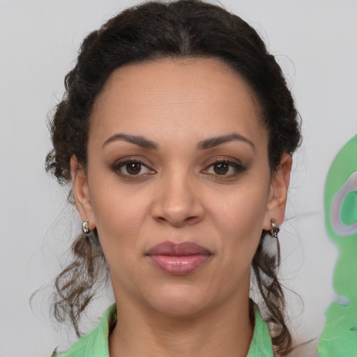Joyful black young-adult female with medium  brown hair and brown eyes