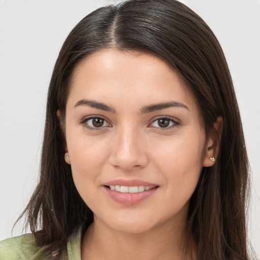 Joyful white young-adult female with long  brown hair and brown eyes