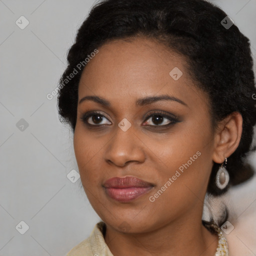 Joyful black young-adult female with long  black hair and brown eyes