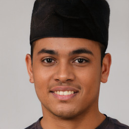 Joyful latino young-adult male with short  brown hair and brown eyes