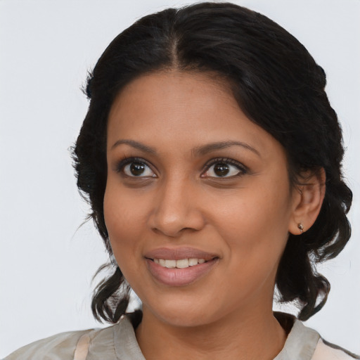 Joyful black young-adult female with medium  black hair and brown eyes