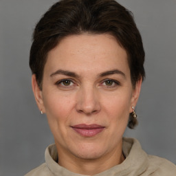 Joyful white adult female with short  brown hair and grey eyes