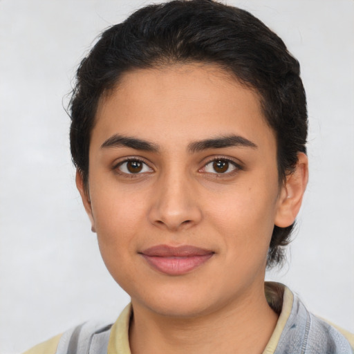 Joyful latino young-adult female with short  black hair and brown eyes