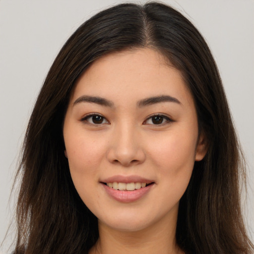 Joyful white young-adult female with long  brown hair and brown eyes