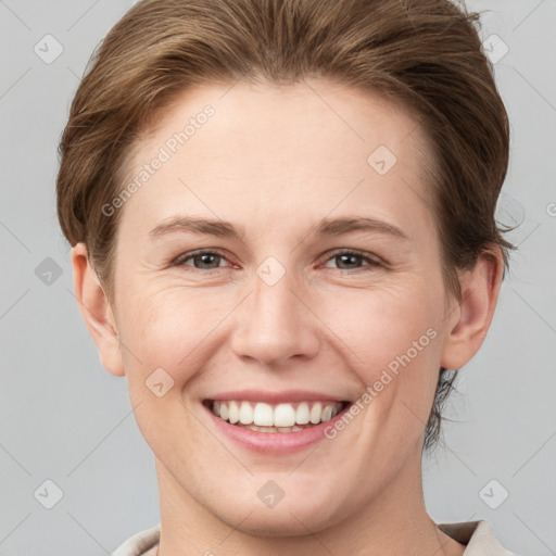 Joyful white young-adult female with short  brown hair and grey eyes