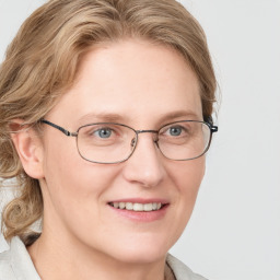 Joyful white adult female with medium  brown hair and blue eyes