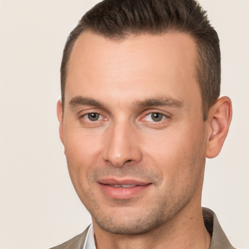 Joyful white adult male with short  brown hair and brown eyes