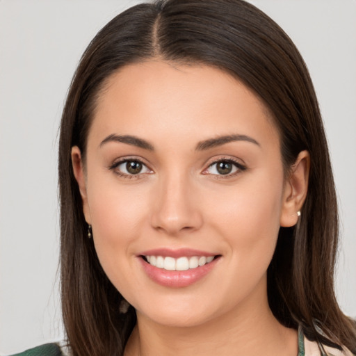 Joyful white young-adult female with long  brown hair and brown eyes