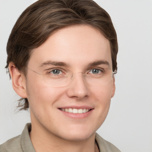 Joyful white young-adult male with medium  brown hair and grey eyes