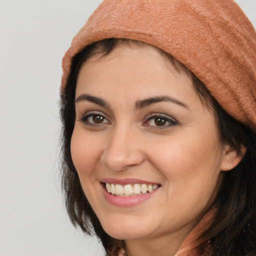 Joyful white young-adult female with medium  brown hair and brown eyes