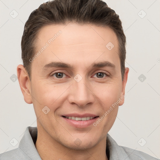 Joyful white adult male with short  brown hair and grey eyes