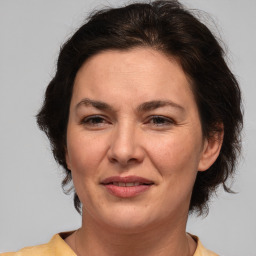 Joyful white adult female with medium  brown hair and brown eyes