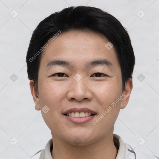 Joyful asian young-adult male with short  black hair and brown eyes