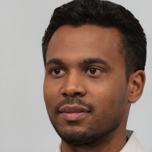 Neutral black young-adult male with short  black hair and brown eyes