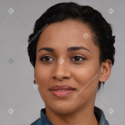 Joyful black young-adult female with short  black hair and brown eyes