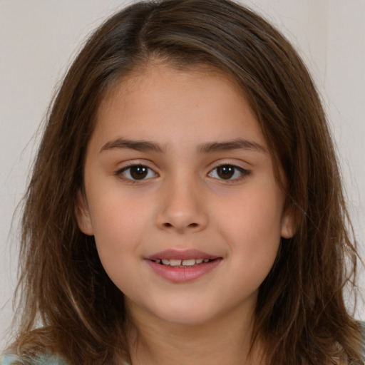 Joyful white child female with long  brown hair and brown eyes