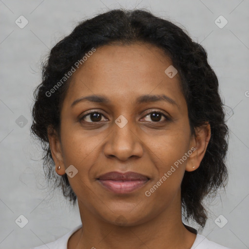 Joyful black adult female with medium  brown hair and brown eyes