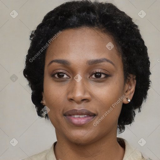 Joyful black young-adult female with short  black hair and brown eyes