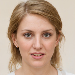 Joyful white young-adult female with medium  brown hair and blue eyes