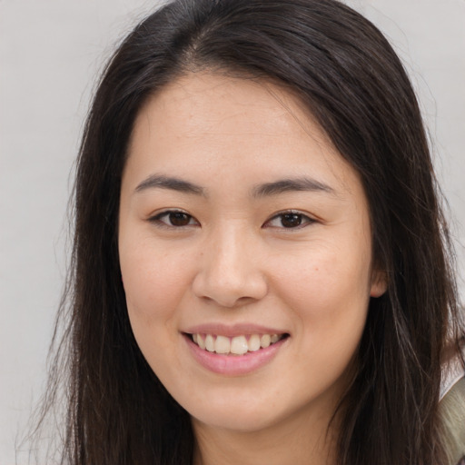 Joyful white young-adult female with long  brown hair and brown eyes